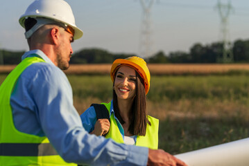 Engineers discussing project at wind turbine farm