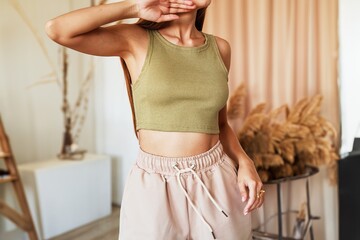 Fitness and fashion fusion with young woman in minimalist studio