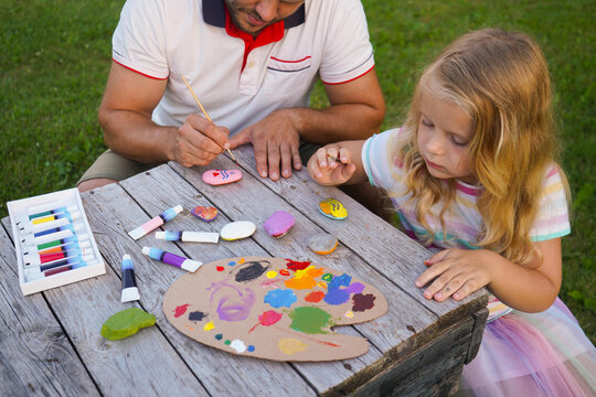 Father, girl child and support with drawing for development, learning art with help for growth