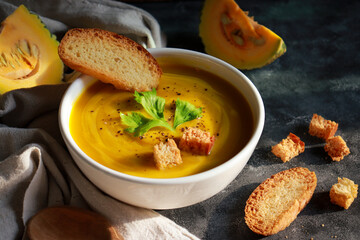 Creamy pumpkin soup in a bowl. Healthy food in Autumn season.