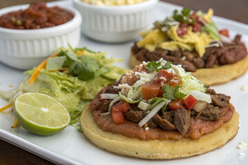 Sopes: Thick Corn Tortillas Topped with Beans, Meat, and Fresh Salsa