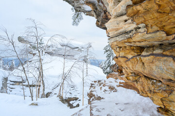 Stone city in the woods moss-grown nature in the winter. Usva, Ural.
