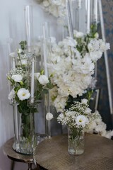 Elegant floral arrangement with white flowers and candles.