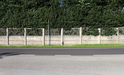 Concrete prefab fence with horizontal bars in the bottom and railing in the upper side. High fence...