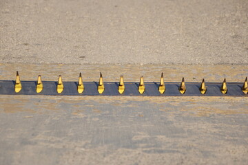 close up of spike road blocker barrier