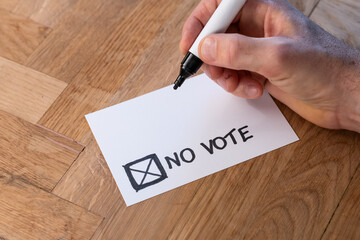 Blank voting card shows no vote. Public opinion opposes an idea or notion. Standing against the subject