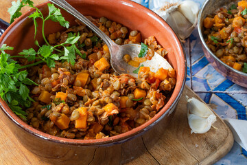 Brown lentils stew with white wine, serrano ham and smoked paprika