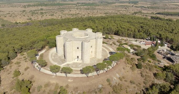 Aerial view of Castel del Monte. It is a castle situated on a hill near Andria in the Apulia region, Italy. A medieval fortress famous for its bold octagonal plan. There is a dense forest around it.