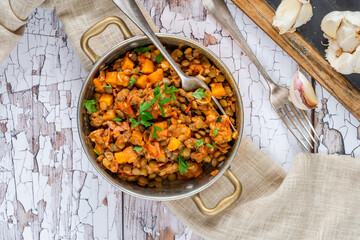 Brown lentils stew with white wine, serrano ham and smoked paprika