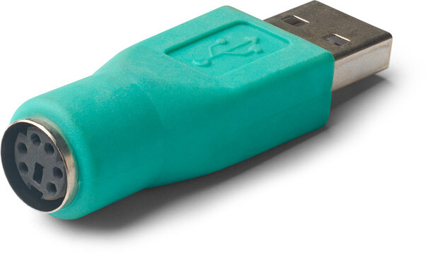 closeup of ps2 to usb converter isolated white background, green color small adapter use to connect older keyboards and mouse to modern usb ports