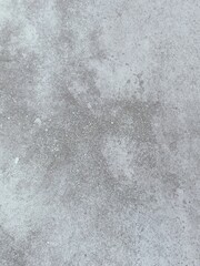 A grey and white wall with a few spots of color