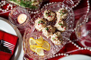 Festive fish table with smocked salmon salad on tartlet shells. Celebration delicacies on Christmas table in Finland and Scandinavia, beautifully served table.