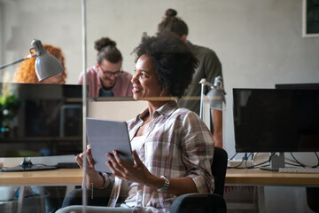 Group of business people and software developers working as a team in modern startup office