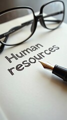 Human resources document with glasses and fountain pen