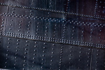 a close up of a metal piece with a metal background