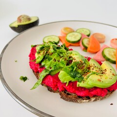 Toast with Beet Hummus with Avocado and Veggies