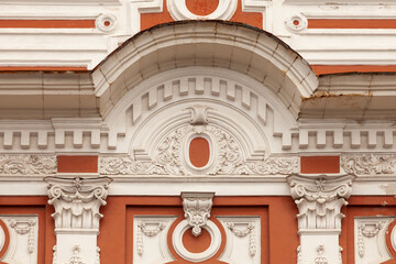 A fragment of the facade of an old mansion decorated with various stucco