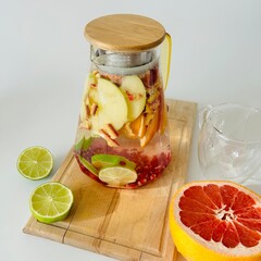 Jug of Tasty Citrus Tea with Lime and Apples
