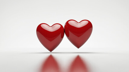 Two glossy red hearts touching, isolated on white background