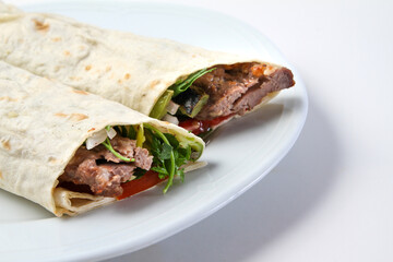 Beef Turkish kebab wrapped in lavash on a serving plate