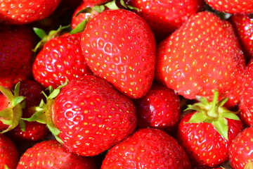 a background of red strawberries isolated macro