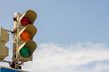 Traffic light on blue sky background, red light on a traffic light, traffic control