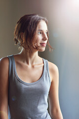 Thinking, home and woman with smile, happy and distracted with ideas, daydreaming and creative for story. Lens flare, contemplating and writer with inspiration, wondering and person with choice