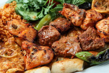 Turkish kebab lamb meat on skewer.
with vegetables and rice on a serving plate