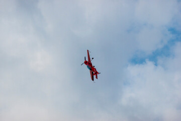 A pilot flies an aerobatic propeller plane in the sky