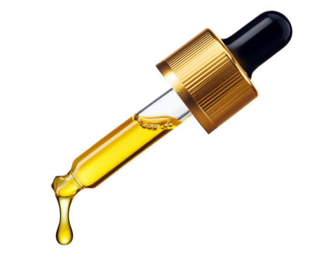 Yellow essential serum oil dripping from gold dropper isolated on white background. Clipping path.