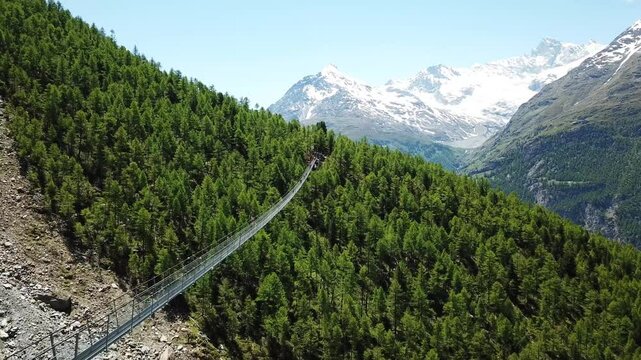 Drone footage revealing tourist enjoying the view while crossing the world record tallest Charles Kuonen H&auml;ngebr&uuml;cke bridge, Randa, Wallis, Switzerland