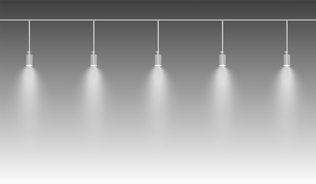 Row of white spotlights hanging from a track. Soft glow illuminating downward, creating a modern lighting effect. Ideal for stage lighting, exhibitions, and interior designs. Stage light