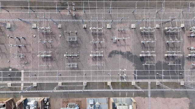 Aerial ascent over electric substation with electrical infrastructure
