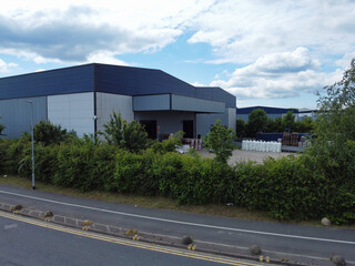 Fototapeta premium High Angle View of Industrial Estate and Warehouses at Leeds City of United Kingdom. Aerial Footage Was Captured with Drone's Camera on June 12th, 2024 from Medium High Altitude.