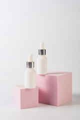 Plastic white tube for cream or lotion. Skin care or sunscreen cosmetic with stylish props on white background.