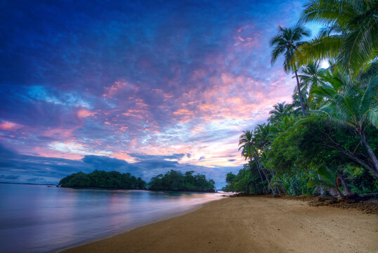 Sunrise at Pacific Beach in Las Perlas archipelago, Pebble and sandy beach looking out over the pacific ocean, Panama, Central America - stock photo