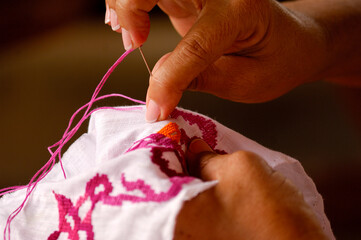 Woman hands sewing a Panama cultural design Pollera national dress, Los Santos,  Panama - stock...