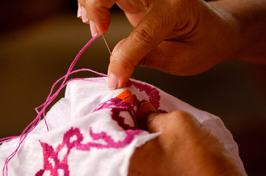 Woman hands sewing a Panama cultural design Pollera national dress, Los Santos,  Panama - stock photo