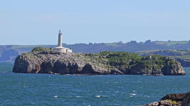 Mouro Island Lighthouse on the rocky island in Santander, Spain.