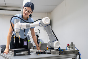 Fototapeta na wymiar Hispanic engineer woman working on AI technology in robotics electronics engineering laboratory. University students' research project is programming robot machine with intelligent mechanical control