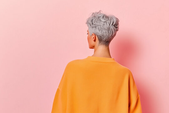 Peaceful Solitude: Woman with Short Gray Hair in a Modern Minimalistic Interior, Captured from Behind with Soft Lighting