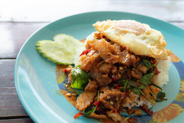  Stir-fried crispy pork with Thai basil and fried egg. Thai food