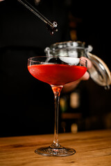 Close-up photo of a stemmed wine glass filled with a brown cold cocktail