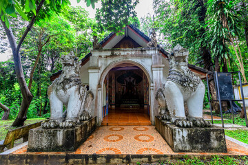 Background of religious tourist attractions on the high mountain on the way up to Doi Suthep, Chiang Mai, Thailand. An ancient temple with beautiful sculptures, Wat Pha Lat, is always popular.