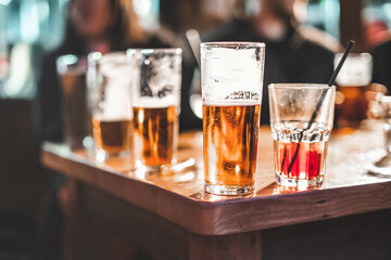 Close-up of assorted half drunk alcoholic drinks on a table in a bar