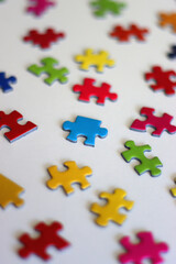 Obraz premium Colorful jigsaw puzzle pieces on white background. Selective focus.