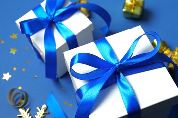 Beautiful gift box tied with bow and Christmas decorations on color background 
