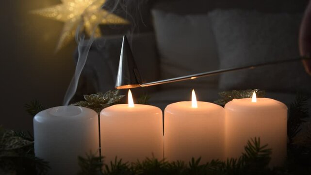 A stainless steel bell extinguishes the flames of four candles in turn.