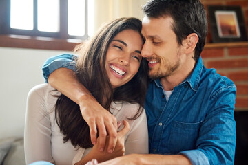Fototapeta premium Home, couple and happy with hug for bonding with memories, support and trust. Apartment, people and smile in relationship as lovers with care, trust and love in living room for loyalty or commitment