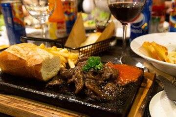 Elegant Restaurant with Steak, Bread, and Wine – Perfect Setting for a Party and Fine Dining Experience
